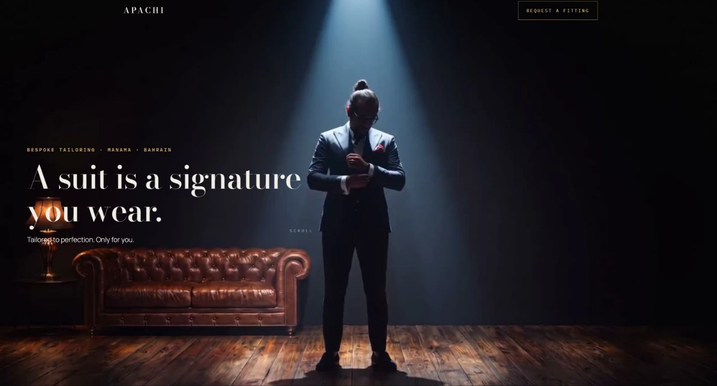 Bespoke tailoring website hero: a tailor adjusting his cuff under a spotlight, with the line A suit is a signature you wear